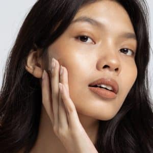 a woman looking at her skin