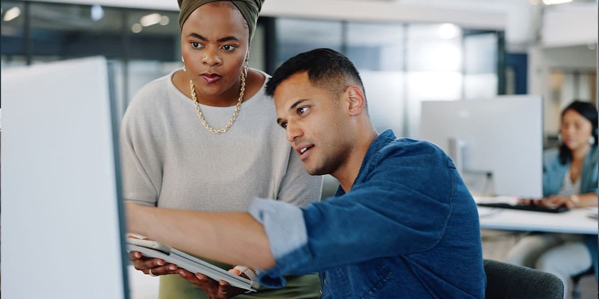 A Person Standing In Front Of A Computer
