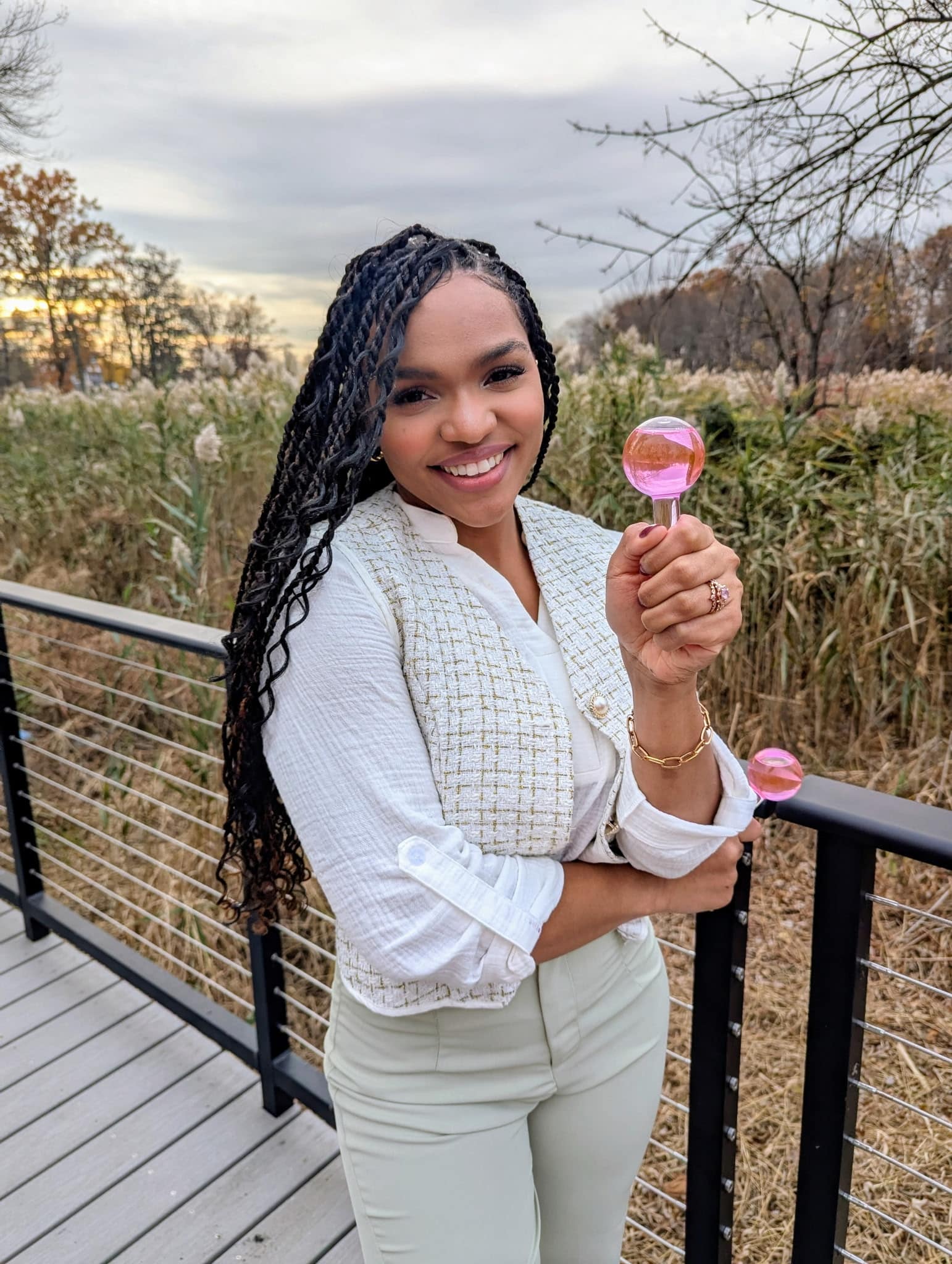 a person standing next to a fence